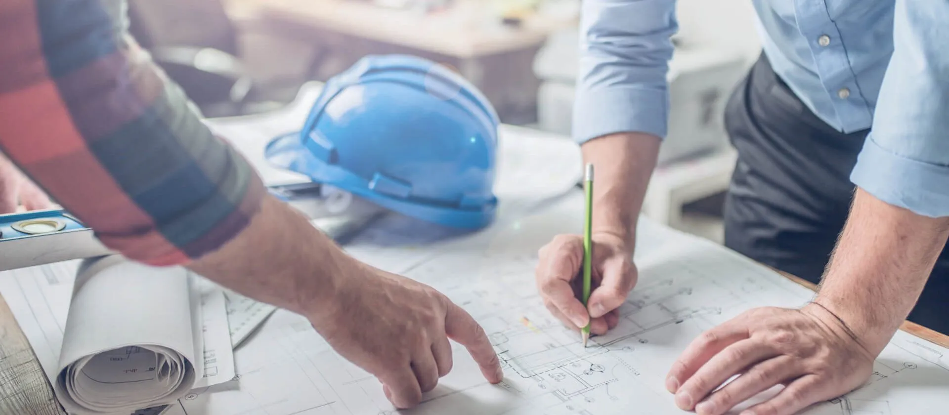2 people looking at a blueprint