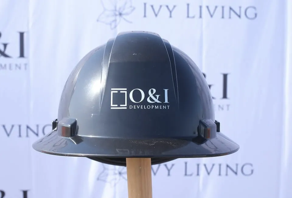 A blue construction helmet with the O & I logo branded on to it.