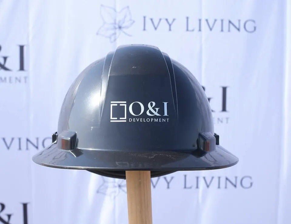 A blue construction helmet with the O & I logo branded on to it.